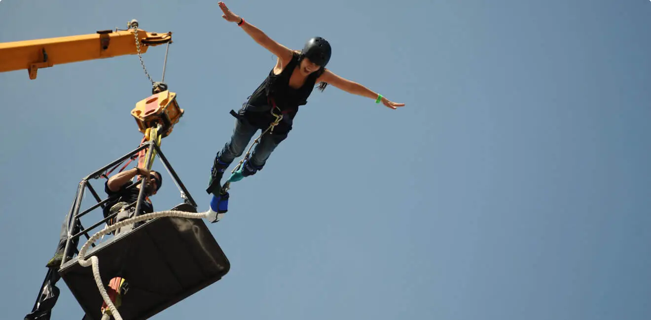 Tandem skydiving freefall over snow-capped Himalayan peaks and river valley