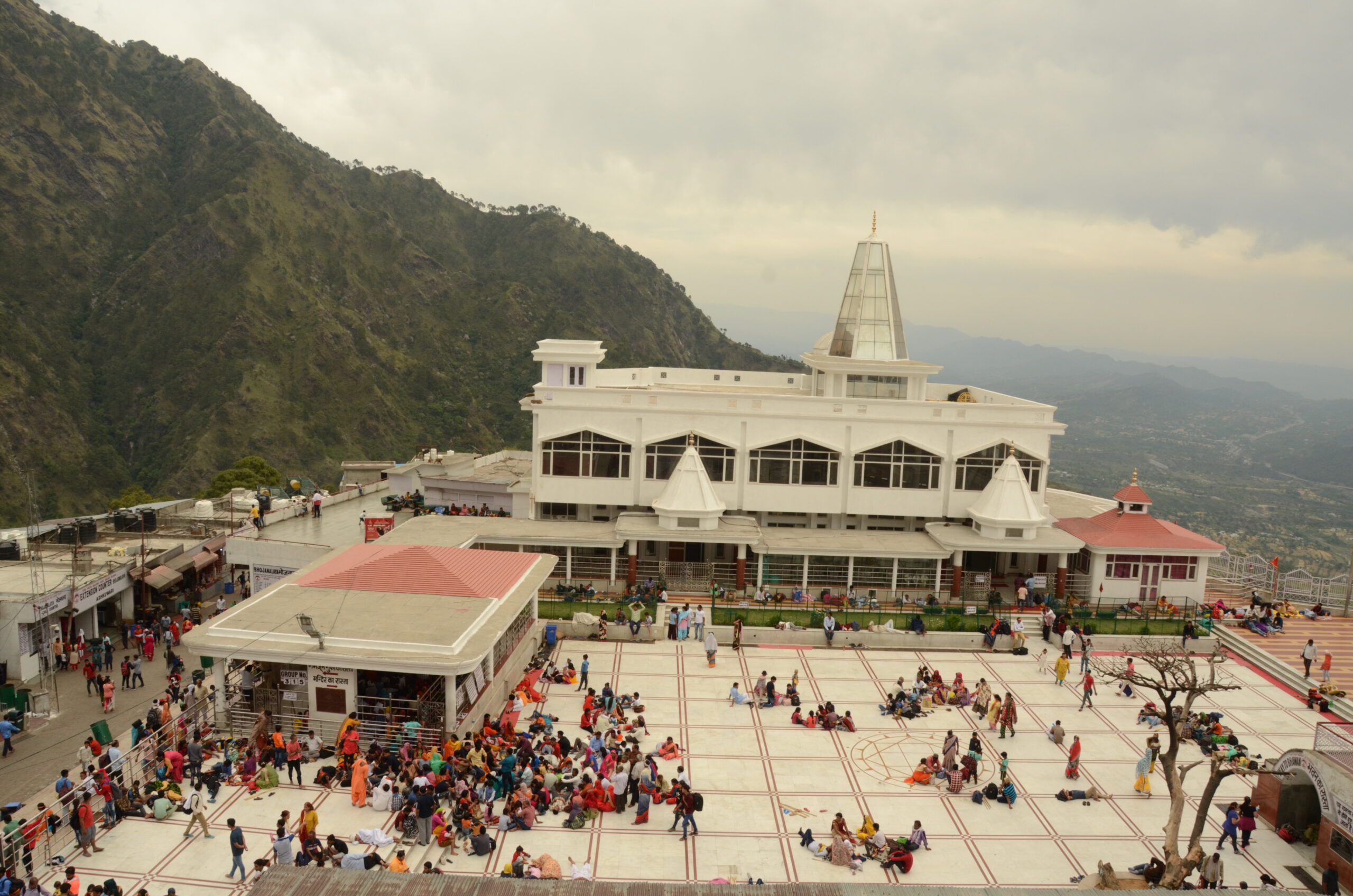 Devotees and scenic mountain path approaching the sacred shrine of Mata Vaishno Devi